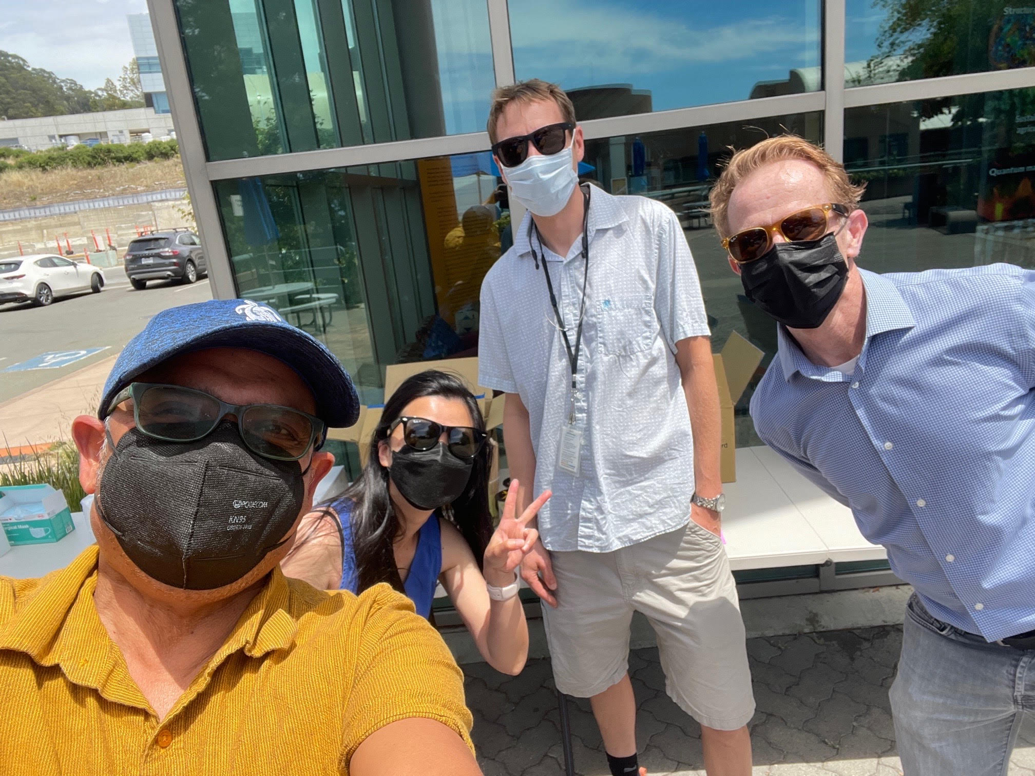 Four people posing in N95 masks