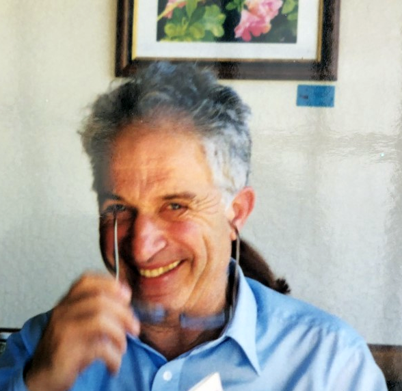 Vladimir Kresin smiling while removing glasses